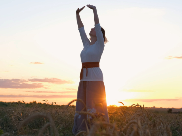 vecteezy_female-practicing-qigong-in-summer-fields-with-beautiful_7665831