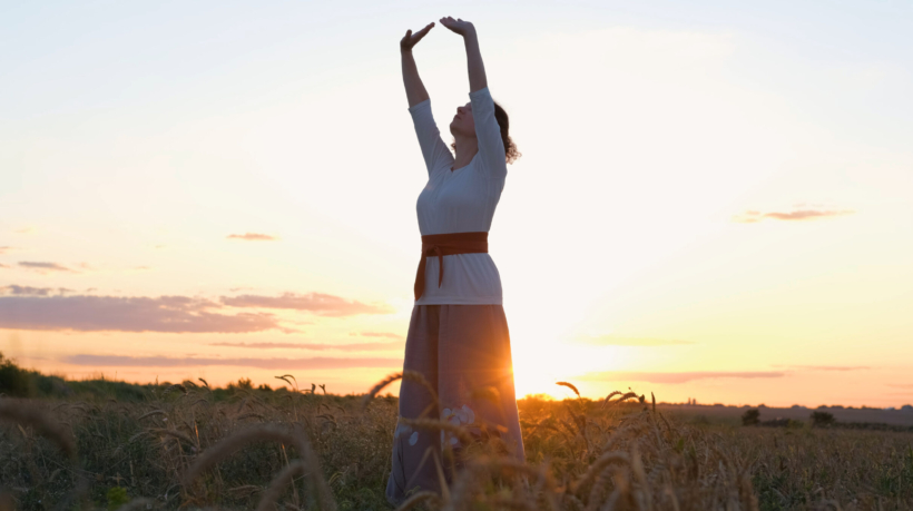 vecteezy_female-practicing-qigong-in-summer-fields-with-beautiful_7665831