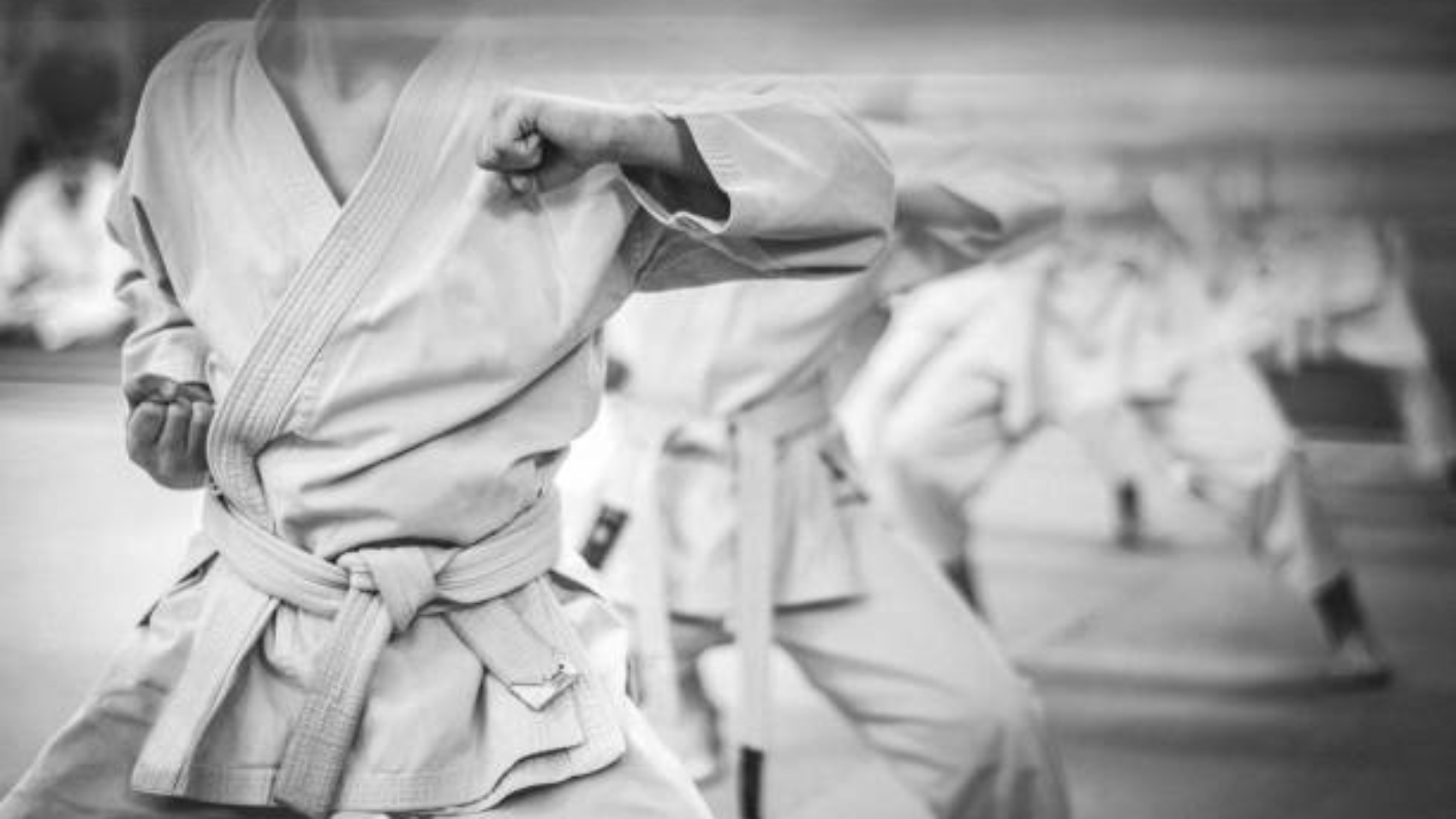 Elbow punch in karate. Children's training. Black and white photo with film grain effect.
